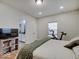 Bedroom with hardwood floors, natural light, and view of the Primary bathroom at 501 W Pearl St, Trafalgar, IN 46181