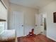 Cozy bedroom showcases hardwood floors, neutral walls, and access to the en-suite bathroom and complements the serene setting at 501 W Pearl St, Trafalgar, IN 46181