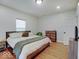 Comfortable bedroom with hardwood floors, natural light, and rustic wood furnishings at 501 W Pearl St, Trafalgar, IN 46181