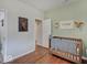 Bright Bedroom features a classic wooden crib, a whimsical deer head, and complements the warm and inviting decor at 501 W Pearl St, Trafalgar, IN 46181