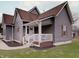Charming home with gray siding, brown roof, white trim, covered porch, and a well-manicured lawn at 501 W Pearl St, Trafalgar, IN 46181