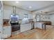 Modern kitchen with white cabinets, stainless steel appliances, and butcher block countertops at 501 W Pearl St, Trafalgar, IN 46181