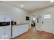Bright, open kitchen with white cabinetry, butcher block counters, and hardwood floors at 501 W Pearl St, Trafalgar, IN 46181