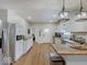 Beautiful kitchen with butcher block countertops, white cabinetry, and stainless steel appliances at 501 W Pearl St, Trafalgar, IN 46181