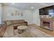 Inviting living room featuring a fireplace, leather sectional, hardwood floors, and neutral tones at 501 W Pearl St, Trafalgar, IN 46181