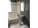 Classic bathroom featuring a pedestal sink, black and white tiled floor, and a shower-tub combination at 5347 N College Ave # Apt 109, Indianapolis, IN 46220