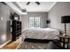 Bedroom with hardwood floors, a large window, and stylish decor at 5347 N College Ave # Apt 109, Indianapolis, IN 46220
