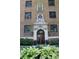 Elegant brick building entrance with ornate detailing and lush landscaping providing a welcoming curb appeal at 5347 N College Ave # Apt 109, Indianapolis, IN 46220