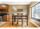 Bright dining area features hardwood floors and a view from the window at 5347 N College Ave # Apt 109, Indianapolis, IN 46220
