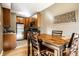 Dining area connected to kitchen featuring a wooden table and hardwood floors at 5347 N College Ave # Apt 109, Indianapolis, IN 46220