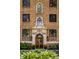 Close-up of the front entrance showcasing the architectural details, plants, and flowerpots at 5347 N College Ave # Apt 109, Indianapolis, IN 46220