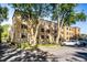 Apartment building featuring a parking lot and shade trees at 5347 N College Ave # Apt 109, Indianapolis, IN 46220