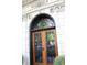 Elegant wooden front door with decorative ironwork and stone surround at 5347 N College Ave # Apt 109, Indianapolis, IN 46220