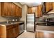 Functional kitchen featuring stainless steel appliances and wood cabinetry at 5347 N College Ave # Apt 109, Indianapolis, IN 46220