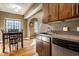 Inviting eat-in kitchen area featuring stainless dishwasher, abundant natural light, and wood floors at 5347 N College Ave # Apt 109, Indianapolis, IN 46220