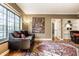 Bright living room featuring hardwood floors, a large window, and stylish decor at 5347 N College Ave # Apt 109, Indianapolis, IN 46220