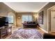 Bright living room with hardwood floors, large windows, and stylish décor at 5347 N College Ave # Apt 109, Indianapolis, IN 46220