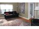 Comfortable living area with hardwood flooring, a classic rug, and an adjacent bathroom at 5347 N College Ave # Apt 109, Indianapolis, IN 46220
