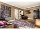 Comfortable living room with a colorful art piece and a hardwood floor under a decorative area rug at 5347 N College Ave # Apt 109, Indianapolis, IN 46220