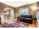 Inviting living room with a large window, hardwood floors, and an elegant area rug at 5347 N College Ave # Apt 109, Indianapolis, IN 46220