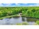 Stunning aerial view of a lakefront home nestled in lush greenery, complete with a private boat dock at 5571 Poff Rd, Martinsville, IN 46151