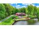 Aerial view of a lakefront home with a dock and lush surroundings at 5571 Poff Rd, Martinsville, IN 46151
