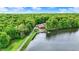 An aerial view of a stunning lakeside home nestled in a lush, green forest at 5571 Poff Rd, Martinsville, IN 46151
