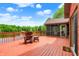 Exterior deck with view of lake surrounded by lush trees with chair and small table at 5571 Poff Rd, Martinsville, IN 46151