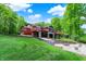Spacious backyard featuring a patio, a grill, and a lake with a dock in the background at 5571 Poff Rd, Martinsville, IN 46151