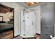Bathroom featuring a glass shower with a corner entry, wood look floors, and grey vanity at 5571 Poff Rd, Martinsville, IN 46151