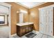 Bathroom with a double sink vanity, white trim, and decorative walls at 5571 Poff Rd, Martinsville, IN 46151