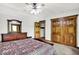 Bedroom featuring wood trim, walk-in closet, ceiling fan, and dresser at 5571 Poff Rd, Martinsville, IN 46151