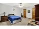 Neutral bedroom with carpet, ceiling fan, standard closet, and a decorative lamp on the nightstand at 5571 Poff Rd, Martinsville, IN 46151