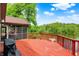 A spacious red deck overlooks the lake, adding charm to the outdoor space with a barbecue and ample room at 5571 Poff Rd, Martinsville, IN 46151