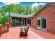 Outdoor deck with a view, featuring wood flooring, wood furniture, and access to a screened porch at 5571 Poff Rd, Martinsville, IN 46151