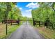 Gated driveway entrance set amidst lush greenery, ensuring privacy and marking the entrance to the property at 5571 Poff Rd, Martinsville, IN 46151
