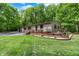Ranch home boasting a deck and multiple garage spaces surrounded by a lush lawn at 5571 Poff Rd, Martinsville, IN 46151