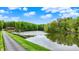 Stunning lakefront property with a lush tree-lined shoreline and beautiful country home in the distance at 5571 Poff Rd, Martinsville, IN 46151