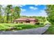 Charming brick home with lush lawn, complemented by the American flag and scenic lake view at 5571 Poff Rd, Martinsville, IN 46151