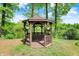Charming gazebo nestled among green trees, offering a serene escape and picturesque views of the lake at 5571 Poff Rd, Martinsville, IN 46151