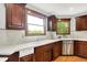 Bright kitchen featuring white countertops, dark wood cabinetry, and stainless steel appliances, perfect for cooking at 5571 Poff Rd, Martinsville, IN 46151