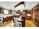 Gourmet kitchen featuring rich wood cabinetry, modern appliances, and a breakfast bar for casual dining at 5571 Poff Rd, Martinsville, IN 46151