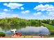 Tranquil view of a lake with a boat dock, surrounded by lush greenery at 5571 Poff Rd, Martinsville, IN 46151