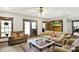 Cozy living room with plush furniture, a glass coffee table, and sliding glass doors to the deck at 5571 Poff Rd, Martinsville, IN 46151