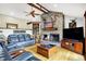 Cozy living room featuring a stone fireplace, wooden accents and comfortable leather furniture at 5571 Poff Rd, Martinsville, IN 46151