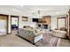 Comfortable living room featuring a stone fireplace, ceiling fan, and access to an additional bedroom at 5571 Poff Rd, Martinsville, IN 46151