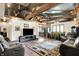 An open living space with wood floors, vaulted ceiling, and exposed wood beams at 5571 Poff Rd, Martinsville, IN 46151
