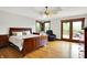 Cozy main bedroom featuring wood floors, neutral decor and a walk out to the porch at 5571 Poff Rd, Martinsville, IN 46151