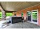 Covered patio with a hot tub overlooking lush greenery, perfect for relaxation and outdoor entertainment at 5571 Poff Rd, Martinsville, IN 46151
