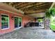 Spacious stone patio featuring brickwork, exposed wood, and stone columns, complete with a hot tub at 5571 Poff Rd, Martinsville, IN 46151